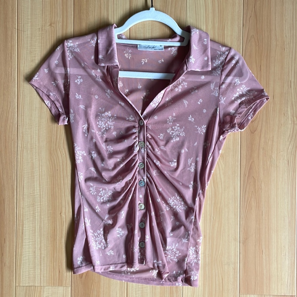 super cute pink button down top, has fun dimension with the flare